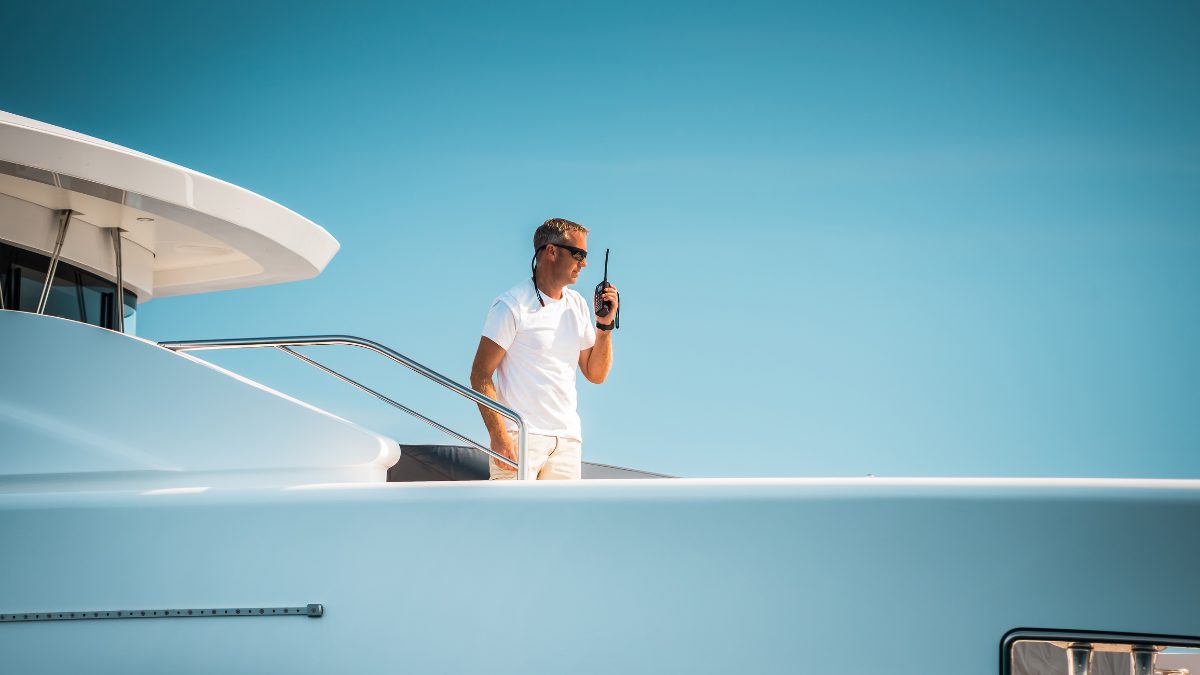 Yacht crew member on walkie talkie