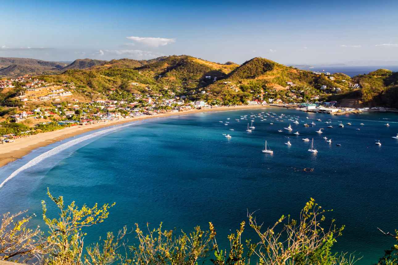 Nicaraguan coast with sandy beach surrounded by various sailing vessels