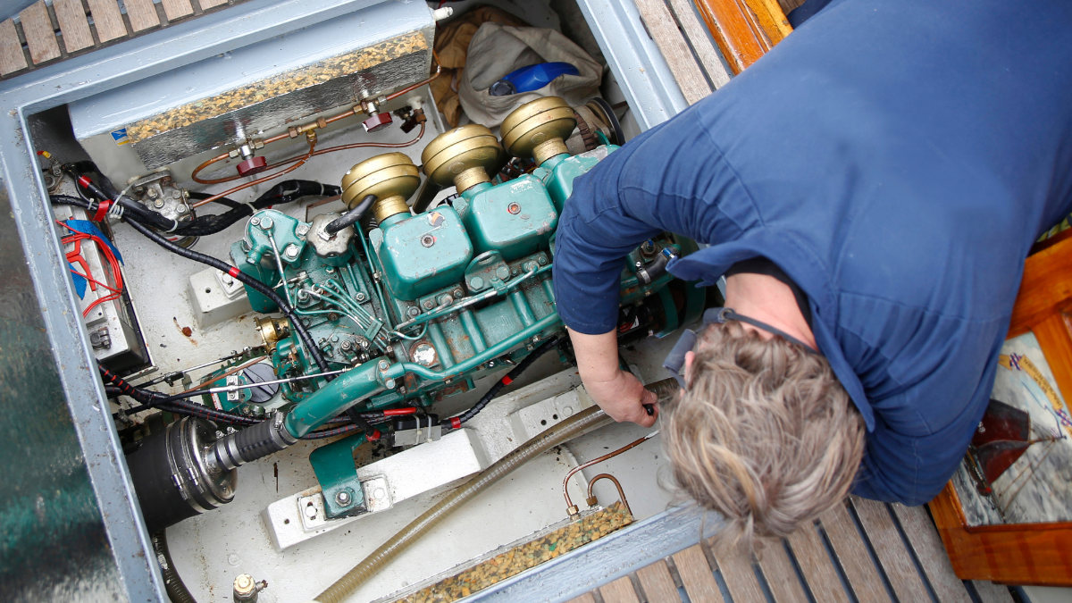 engineer repairing engine on a superyacht